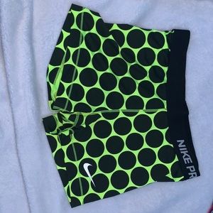 Green and Black Nike Pros